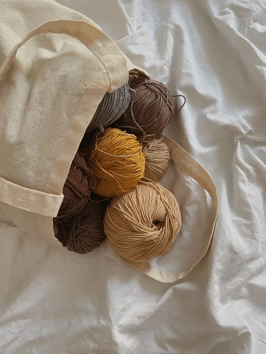 Yarn skeins in a tote over soft fabric