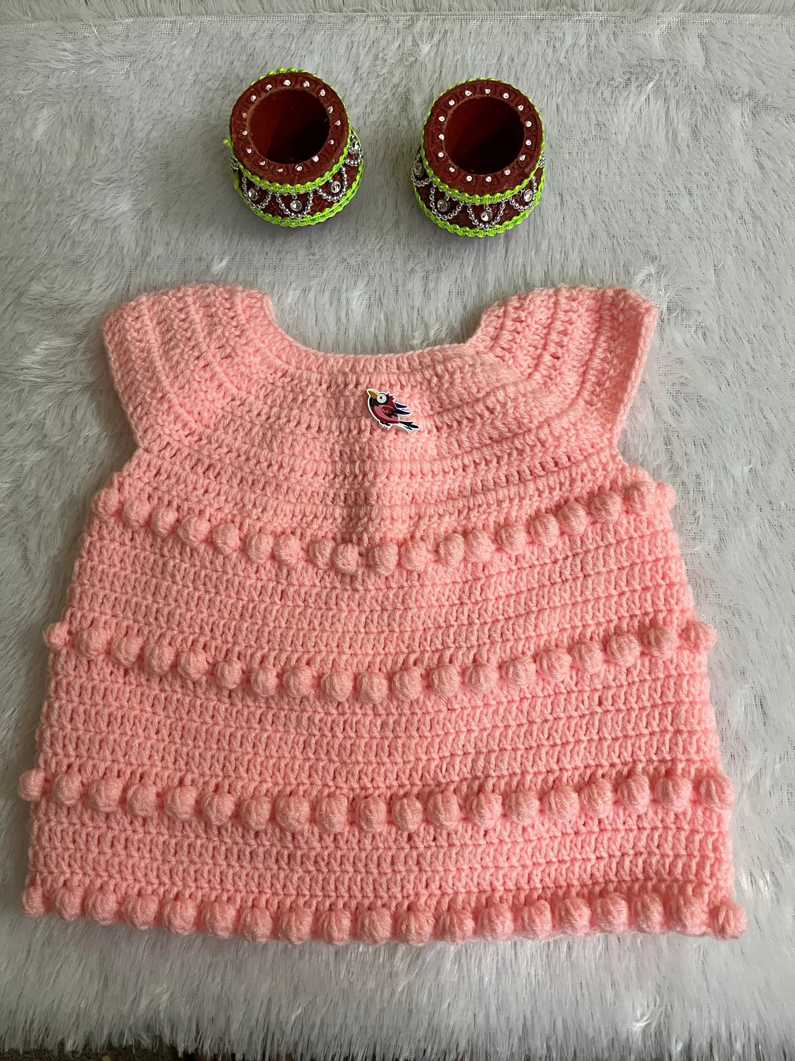 Pink crochet baby top with bobble stitch
