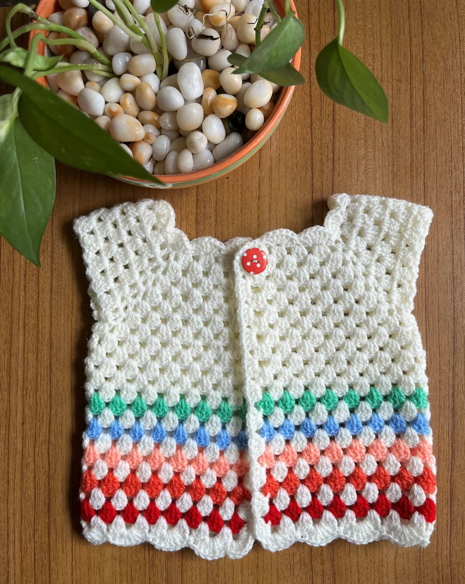 White crochet baby cardigan with colorful striped border