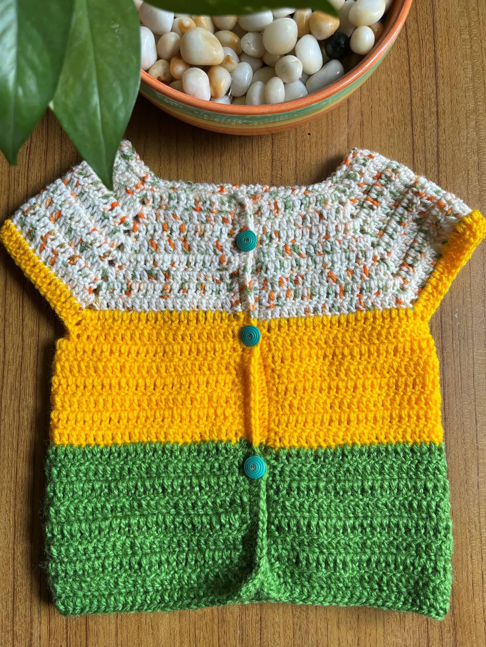 Yellow and green crochet baby cardigan with buttons